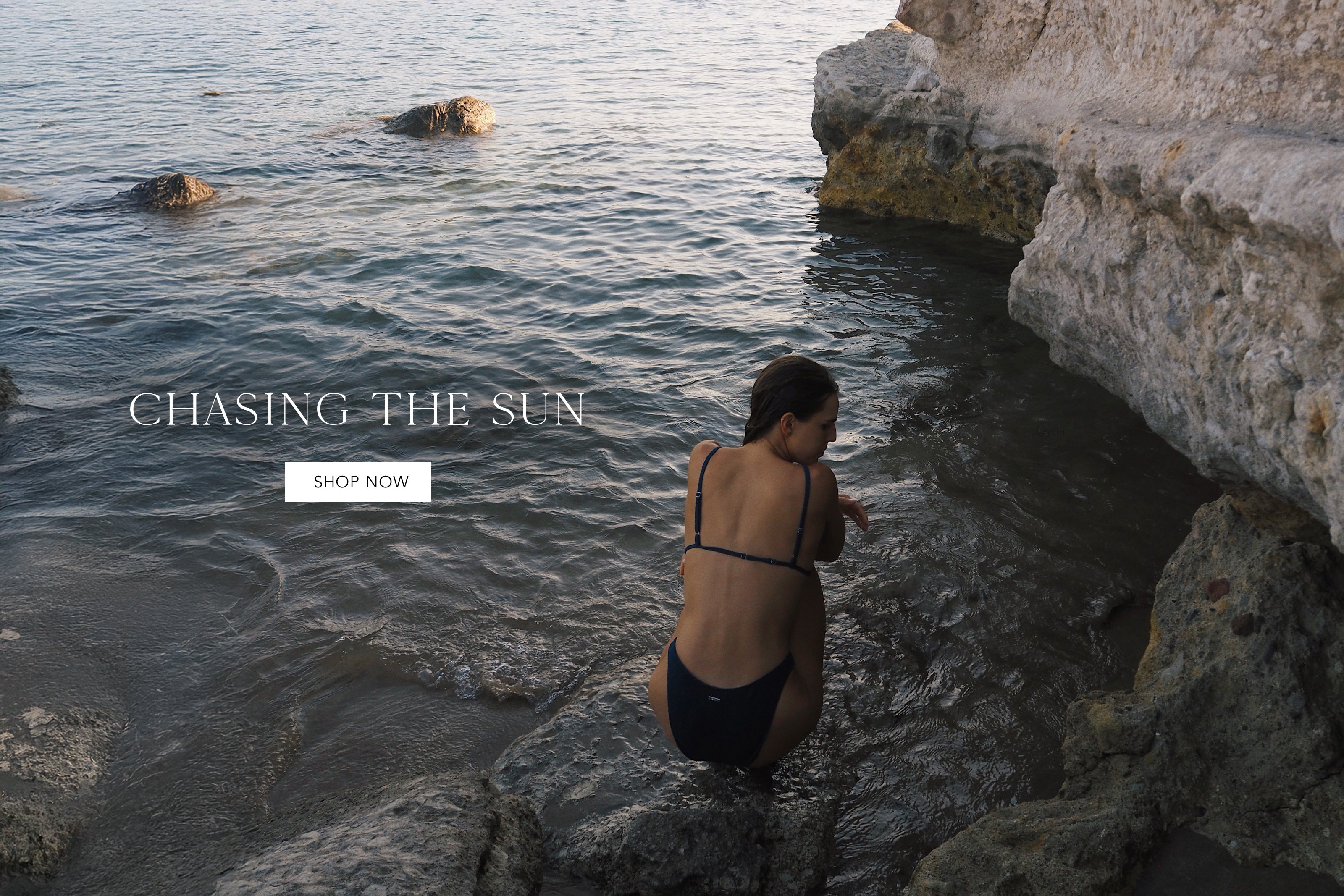Person in a swimsuit sitting on rocks by the water with 'Chasing the Sun' text overlay.